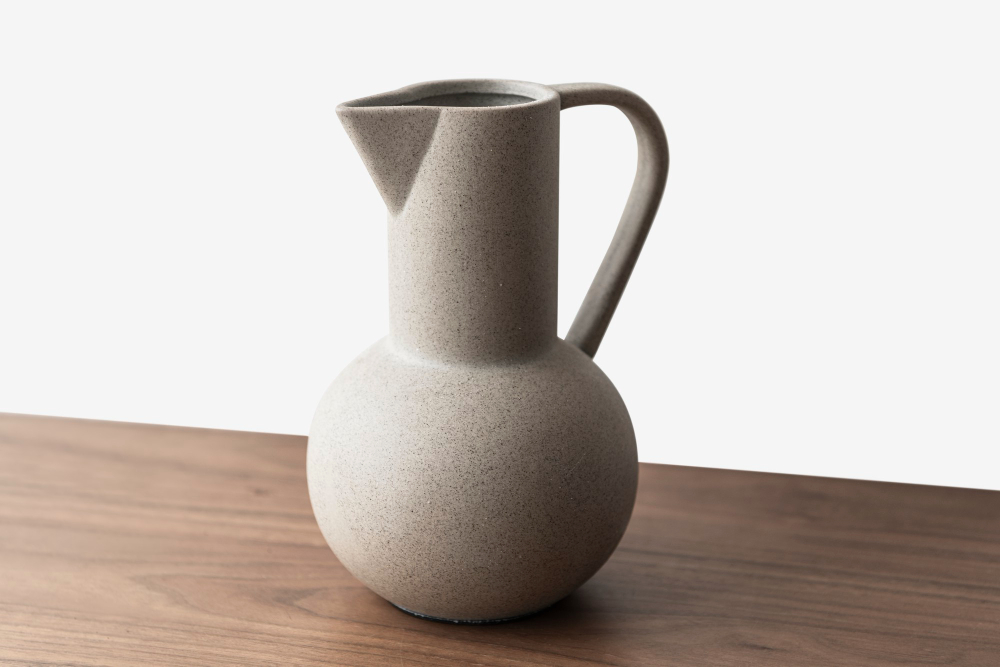 black-textured-ceramic-jug-vase-wooden-table.jpg